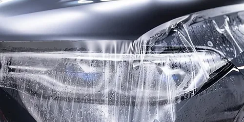 Paint protection film being installed over a headlight